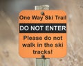 Sign saying âdo not enterâ - âone way ski trailâ - taken in late Winter on a sunny day Royalty Free Stock Photo